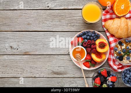 Collage of Breakfast Items on a Wooden Table With Fruits, Honey, and Drinks in Different Dishes Stock Photo
