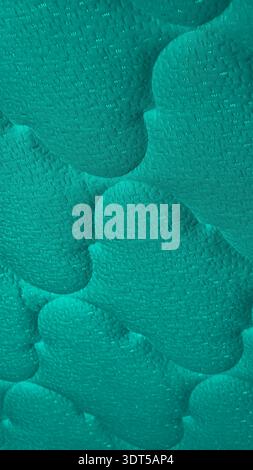 Turquoise flowing forms create a serene 8K wallpaper vertical background with generous copy space for a refined modern phone screen. Stock Photo