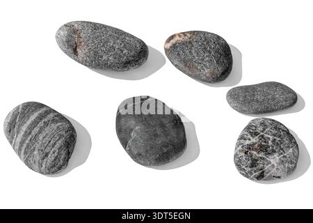 Perspective view isolated on white or transparent background of six grey river stones. Professional studio lighting emphasizes striped and speckled Stock Photo