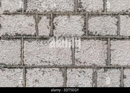 Ancient grey stone wall texture with rough masonry blocks. Authentic weathered limestone background of a historic building Stock Photo