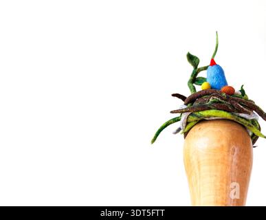 Needle felted blue bird nest fascinator with wool eggs on a wooden millinery hat block, isolated on a white background with large copy space Stock Photo