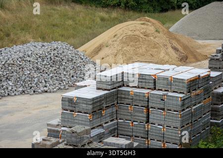 Construction Supply Yard With Sand Gravel And Concrete Paving Block Pallets. Stock Photo
