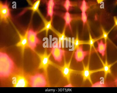 Colorful blurred LED lights creating abstract bokeh background. Festive glowing illumination with blue, yellow and pink tones, holiday decoration conc Stock Photo