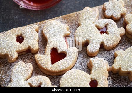 Animal shaped homemade Linzer Easter cookies filled with strawberry marmalade and dusted with sugar Stock Photo