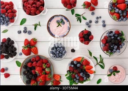Colorful Arrangement of Berries and Yogurt in a Collection on a Table Stock Photo