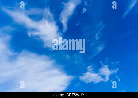 Deep blue sky with dramatic white cirrus clouds Stock Photo