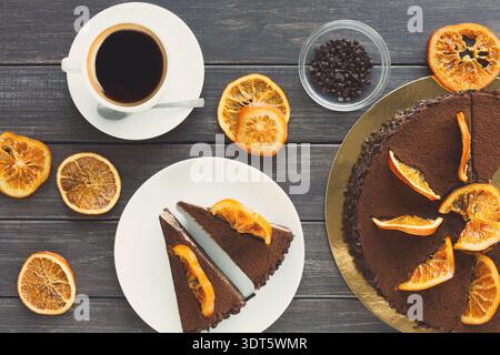 Collection of Desserts and Drinks on Wooden Table With Dried Orange Slices and Chocolate Cake Stock Photo