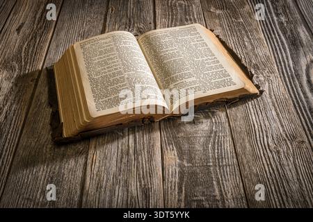 Old worn bible on wooden background, USA Stock Photo
