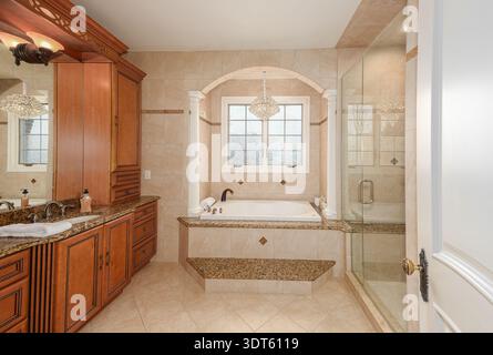 custom bathroom renovation has new ceramic tiles and fixtures installed Stock Photo
