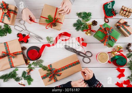 Creating Gift Packages With Decorations and Tools During the Holiday Season at Home With Family Stock Photo