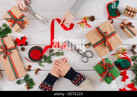 Gift Wrapping Session With Friends During the Holiday Season at a Cozy Table in December Stock Photo