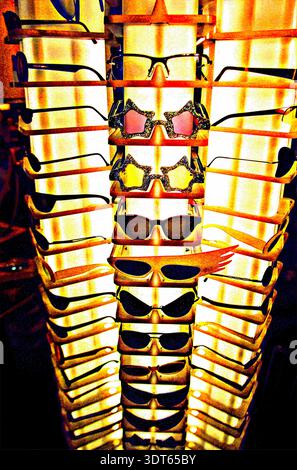 stand is full of sunglasses in different styles and colors. The glasses are arranged in rows, with light shining through them. This display shows many Stock Photo