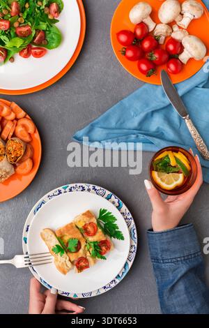 Colorful Salad and Meal Selection With Drinks on a Table in a Cozy Setting Stock Photo