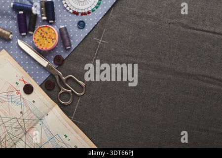 Creative Set of Sewing Tools and Fabric Pieces Arranged in a Collage on a Worktable Stock Photo