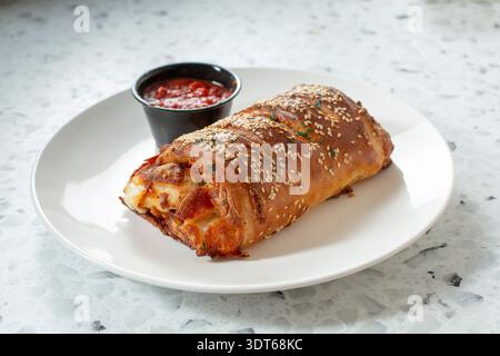 A view of a pepperoni and cheese stromboli. Stock Photo