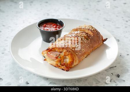 A view of a ham and cheese stromboli. Stock Photo
