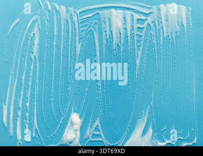 Collage of Cleaning Patterns on a Blue Surface With Bubbles and Foam From Soap Stock Photo