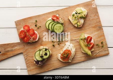 Healthy Collage of Small Sandwiches on a Wooden Board With Different Toppings Stock Photo
