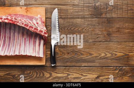 Raw Meat Preparation on Wooden Cutting Board With Knife for Cooking in the Kitchen Stock Photo