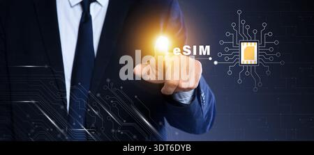 Businessman activating eSIM microchip on virtual screen, closeup. Dark background Stock Photo