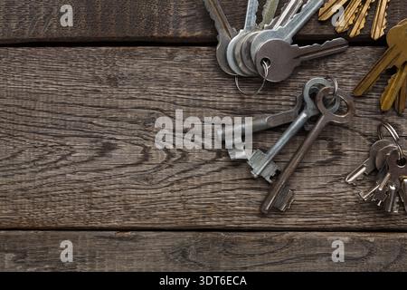 Collection of Old Keys Arranged on a Wooden Surface Stock Photo