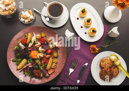 Colorful Food Collage Featuring Various Dishes and Drinks on a Dark Table Setting Stock Photo