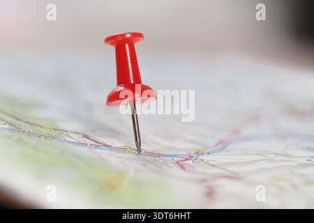 Red pin marks a location on a map during planning Stock Photo