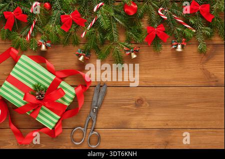 Collection of Gifts, Decorations, and Tools on a Wooden Table During a Holiday Preparation Session Stock Photo