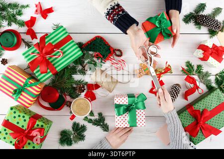 Collection of Colorful Gift Boxes and Wrapping Materials on a Table During a Festive Setting Stock Photo