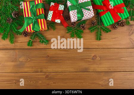 Collection of Colorful Gift Boxes on Wooden Table With Greenery for Holiday Celebration Stock Photo