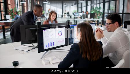 Analytical Team Led By Diverse Manager Analyzing Financial Data Dashboard. Stock Photo