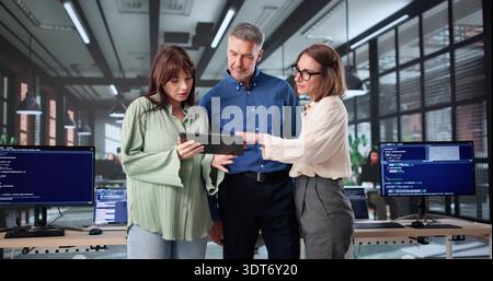 Senior Web Developers Meet At Night To Discuss Software Projects Stock Photo