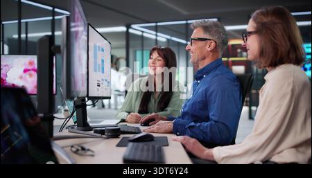 Young Woman Presenting Design Project To Team In Modern Office. Stock Photo