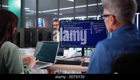 Senior Developers Coaching AI Team In Secure Business Code Office. Stock Photo