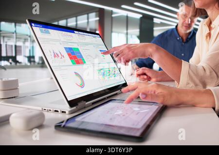 Analytic Data Display On Tablet In Digital Business Team Meeting Stock Photo
