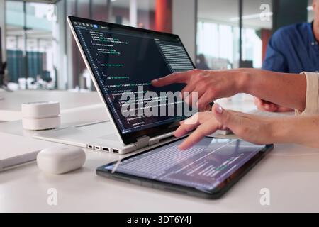 Female Programmer Creating Software Application With Team In Office Setting Stock Photo