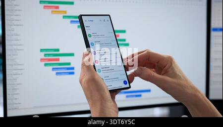 Fraudulent Email Received On Smartphone With Scam Link, Beware Woman. Professions: Cyber Security Specialist Stock Photo