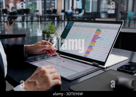 Woman Analyzing Corporate Invoices On Office Computer For Payroll Duties. Stock Photo