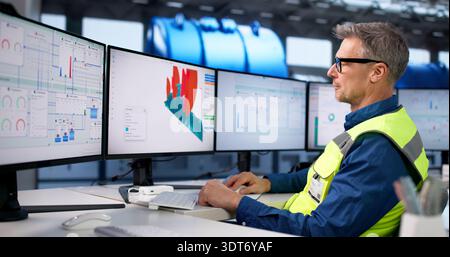Engineer Using SCADA Software To Monitor Gas Turbine At Plant. Stock Photo