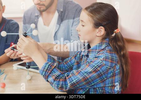 Students Learn About Molecules Through Hands-On Activities in Classroom Stock Photo