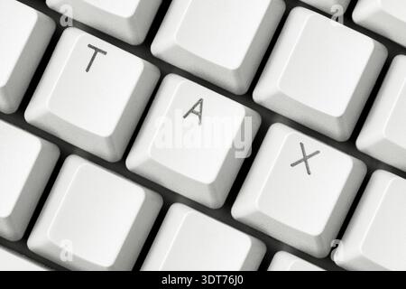 Tax filing time. Tax word on computer keyboard keys Stock Photo