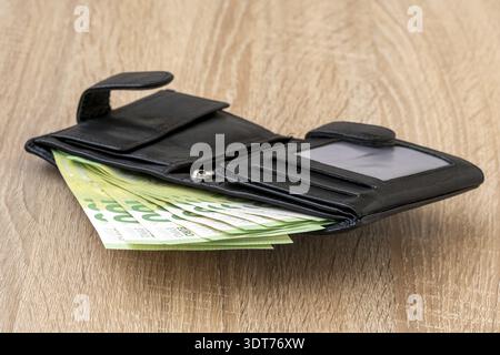 Leather wallet with Euro currency on wooden table Stock Photo