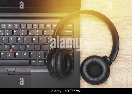Digital music creation theme with professional headphones on the computer keyboard Stock Photo