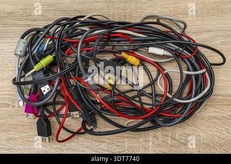 Bundle of various cables with various connectors suitable for different ports. Concept of great number of pc peripherals, equipments and connected dev Stock Photo