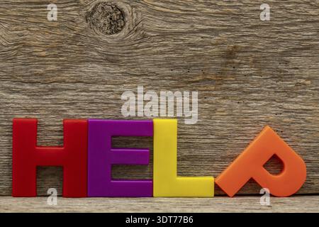 Word HELP made of color plastic letters. Help or assistance concept Stock Photo