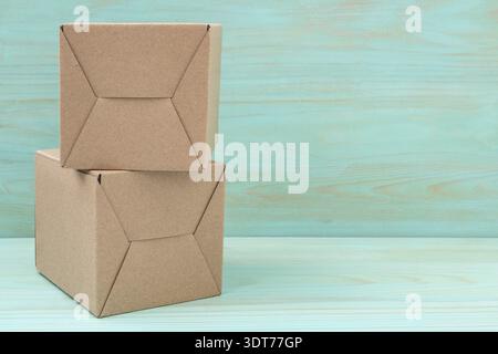 Stack of cardboard boxes on blue wooden background. Copy space Stock Photo