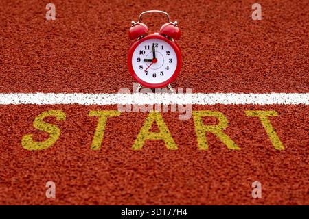 Alarm clock with the word START on the road in the morning. Start, Start-up, New Career or New Business, Mindset Concept Stock Photo