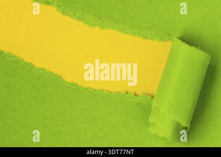 Green paper torn to reveal yellow copy-space ideal for your text Stock Photo