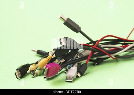 Close up view of old wires and cables lying on the light blue background Stock Photo