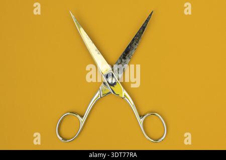 Very sharp retro professional tailor scissors on yellow background Stock Photo
